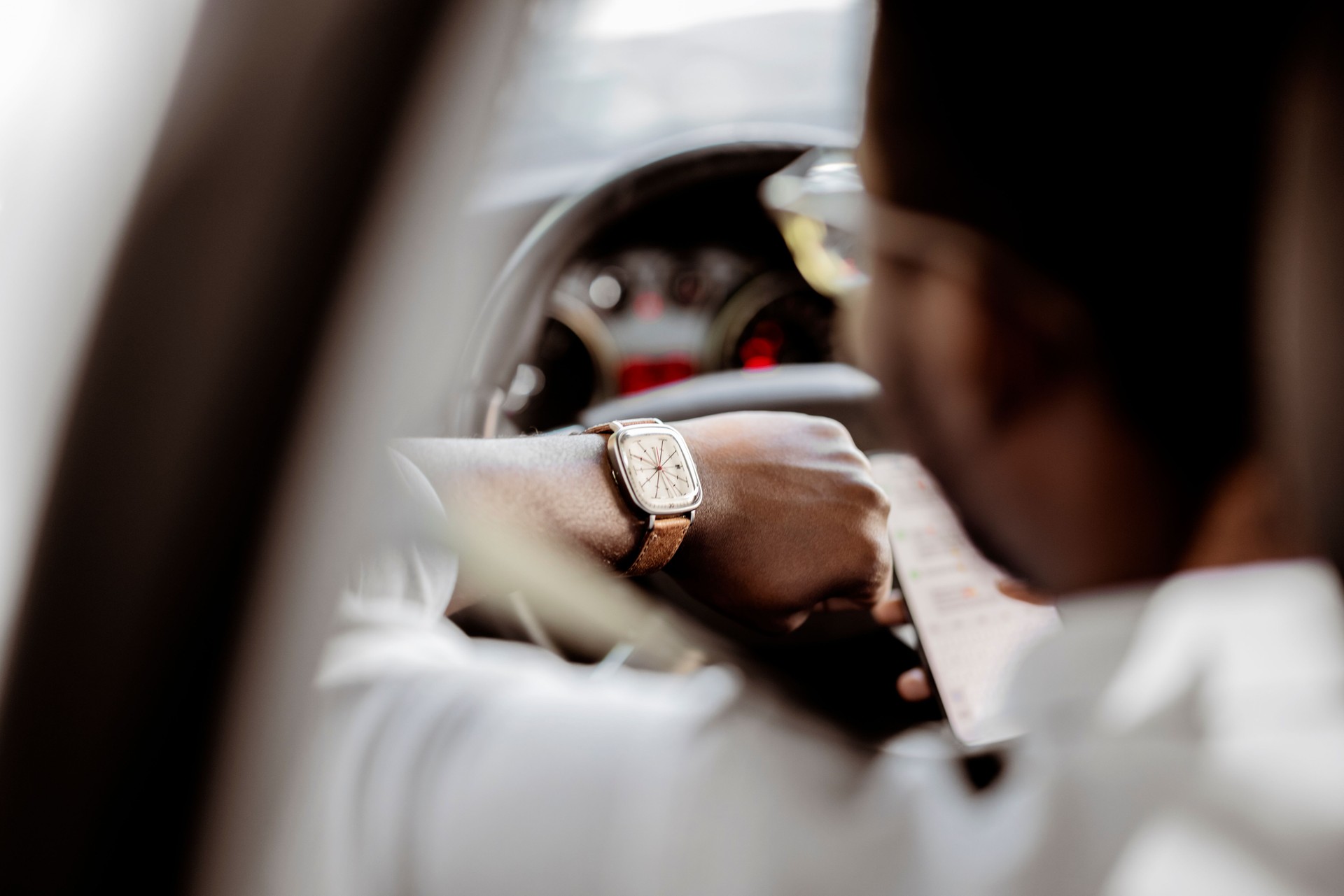 Man Looking at the Watch While Sitting in a Car